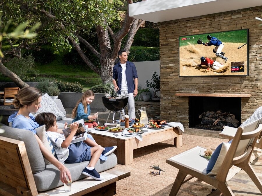 A family enjoying an upgraded outdoor video setup in their backyard. 