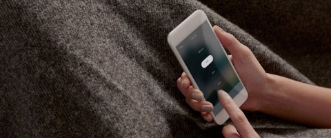 A homeowner using their Savant app interface to access all their smart home automation systems and solutions. 