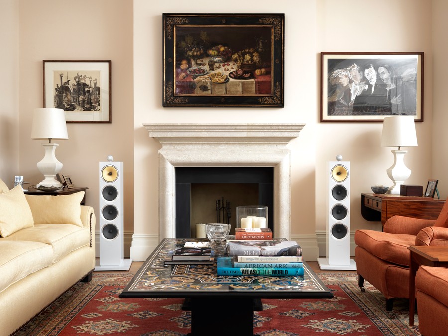 A living room featuring Bowers and Wilkins speakers on either side of the fireplace. 
