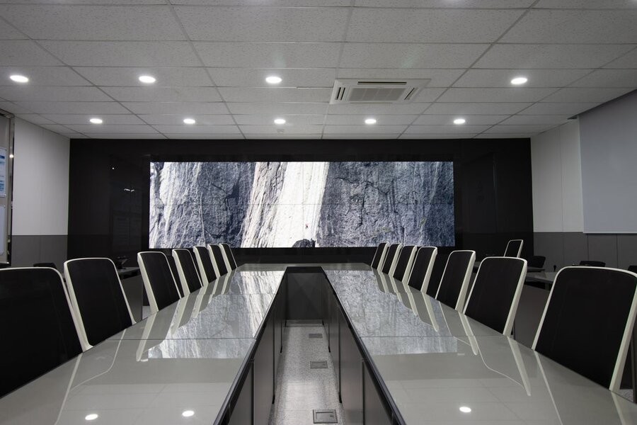 A conference room featuring a large video wall.