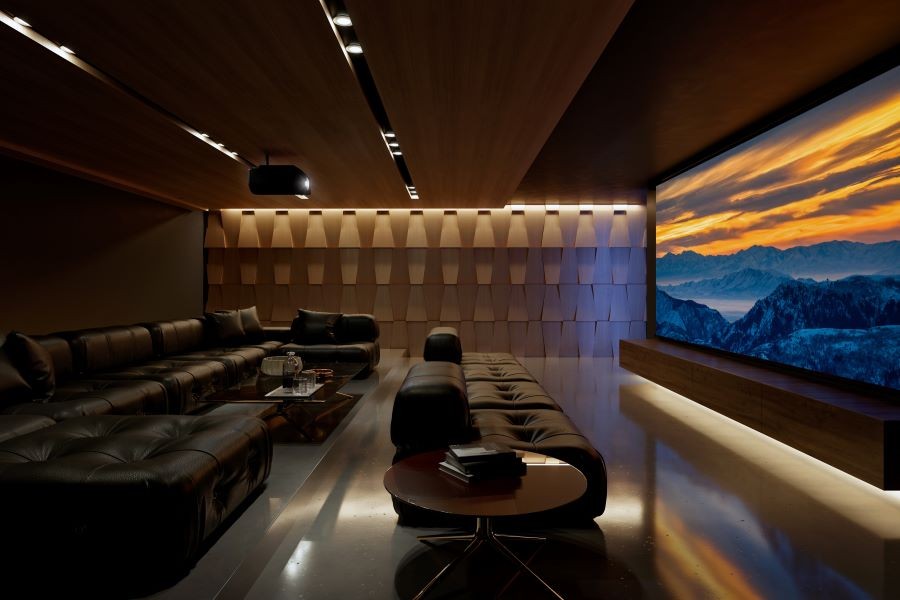 A home theater with a Sony projector, large movie screen, tiered sectional seating, and acoustic paneling.