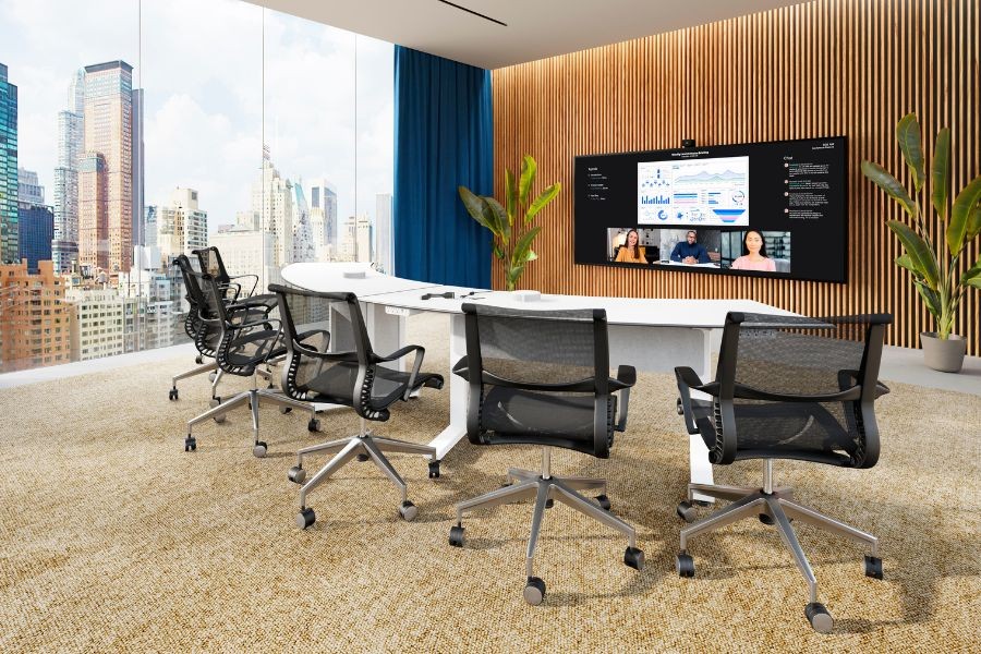 Photo of a beautiful meeting room with the view of the city outside, a large television placed on the wall in front of the table. 